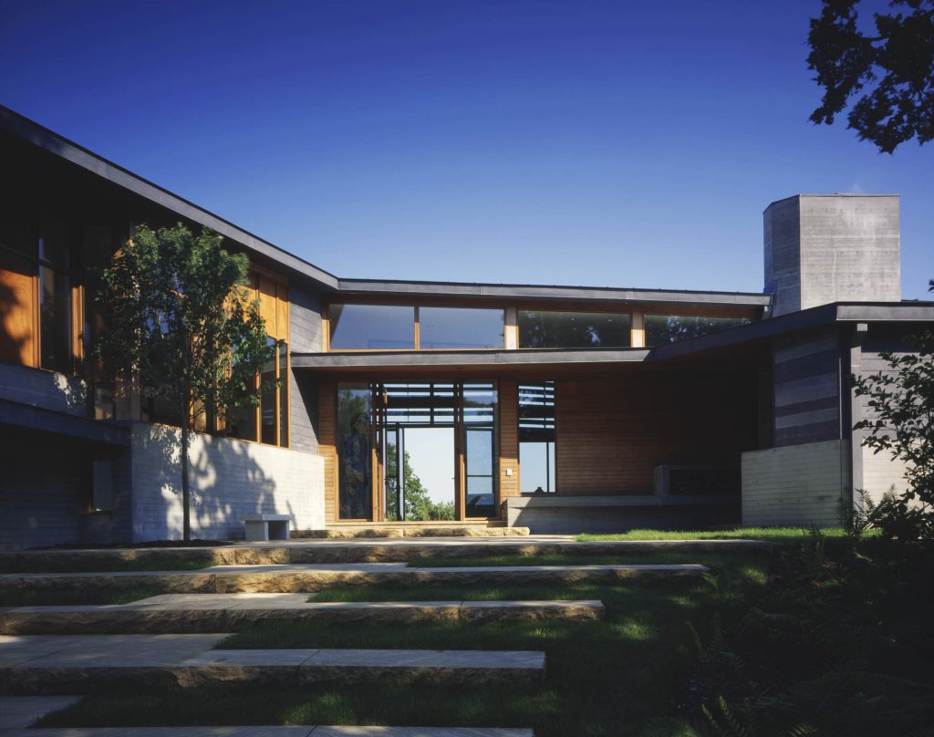 A breezeway with doors on both sides allows one to see through this modern home.